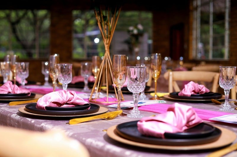 Elegant Table Setting with Pink Decor and Crystal Glasses