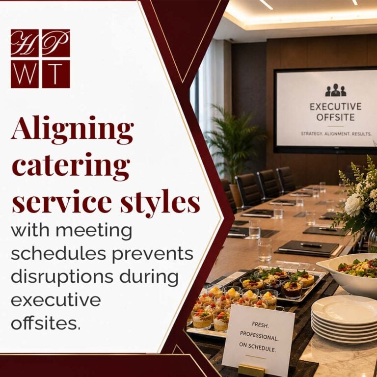 A catering table with individual parfait desserts, fresh salad, and plates set up in front of an executive boardroom table and presentation screen.