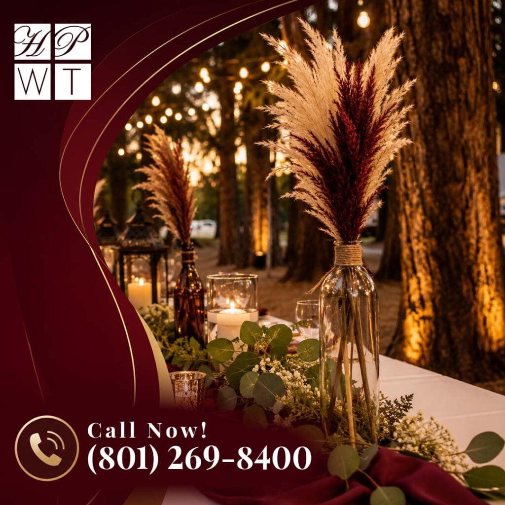 How Does Full-Service Event Catering Prevent You From Overspending? 2 A rustic outdoor event table display featuring pampas grass vases, eucalyptus greenery, and glowing candles in a wooded setting.