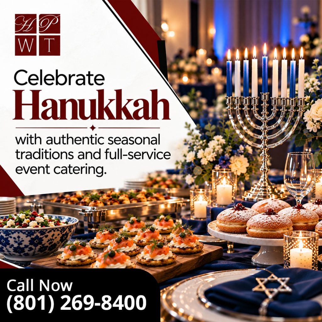 An elegant Hanukkah catering display featuring a lit silver menorah, smoked salmon latke appetizers, powdered sugar sufganiyot jelly donuts, and candlelit blue table decor.